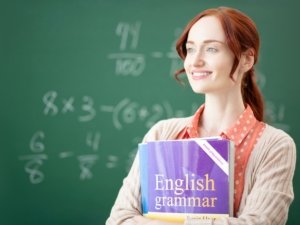 Red-haired English teacher feeling thoughtful before lesson