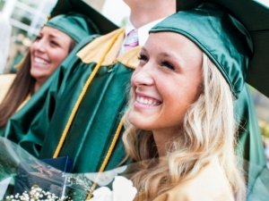 Close-up Of Happy Young Woman With Friends At Graduation Ceremony