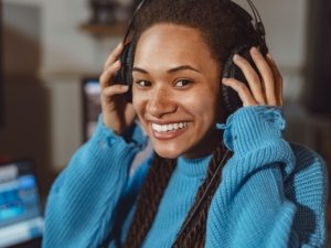 Radio concept - close-up of African American woman speaking on the radio, working as a presenter