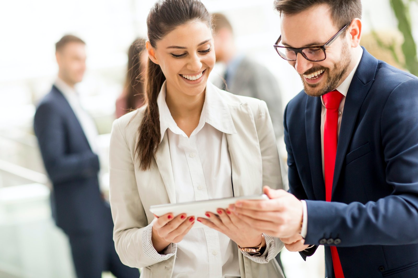 Business couple working on tablet in office