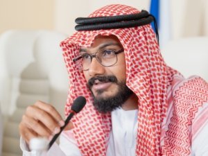 Young delegate from United Arab Emirates speaking in microphone