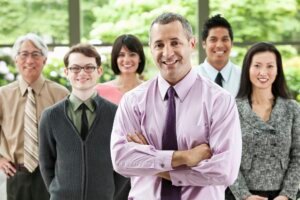 A portrait of a mixed race team of business people with a Caucasian businessman in the lead.