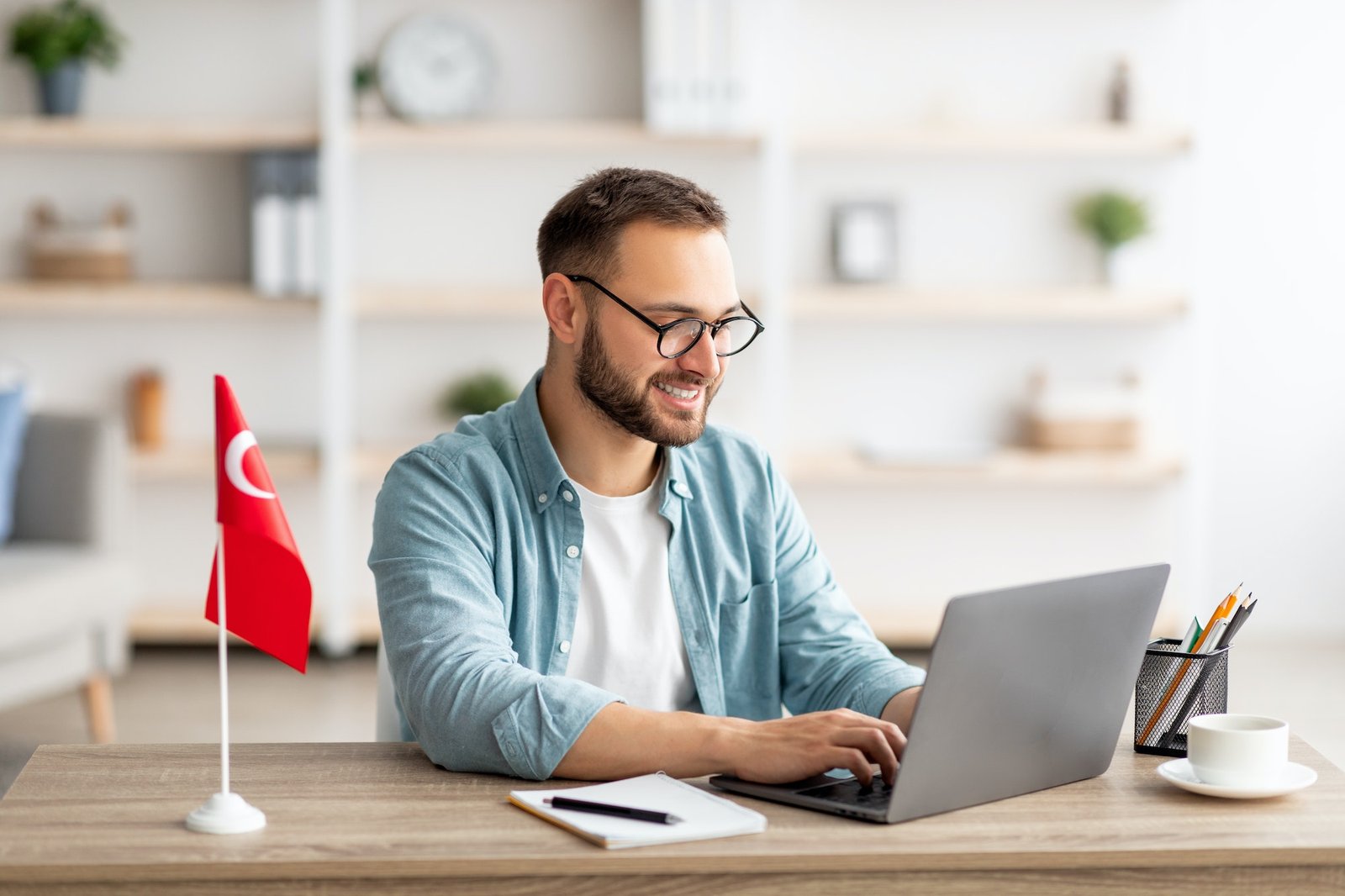 Millennial male tutor with laptop teaching Turkish online from home