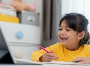 Asian little girl taking class on line and happy for Homeschool Quarantine coranavirus pandemic