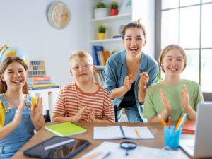 Happy kids and teacher at school