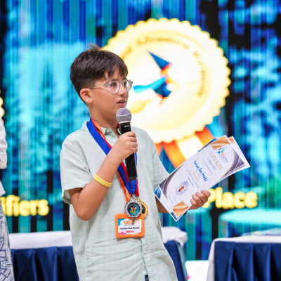 Young speaker with medals and certificates