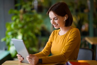 Cheerful attractive young businesswoman having online business meeting