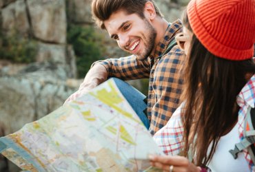 Cropped image of adventure couple with map