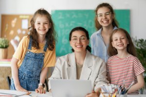 Happy kids and teacher at school