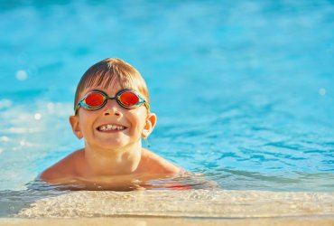 Picture of young boy playing in outdoor aqua park