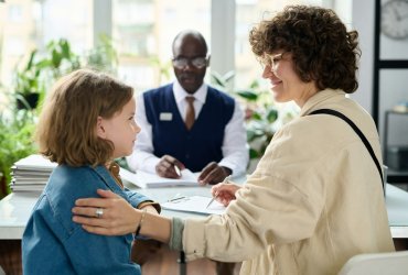 Young mother and child smiling in social workers office